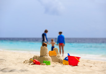 sand castle and toys on tropical beach