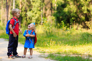 Fototapeta premium happy little boy and girl with backpacks in summer