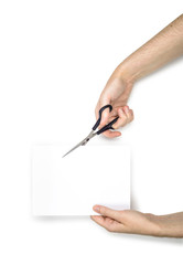 Hand cutting a sheet of paper with scissors