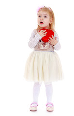 Little girl holding heart