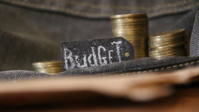 budget concept, chalk inscription and gold coins