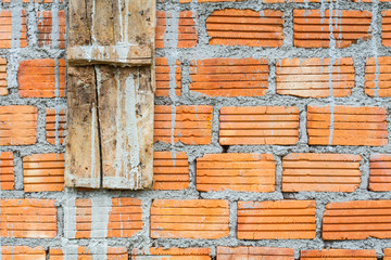 closeup orange horizontal textured brick with dry concrete stain