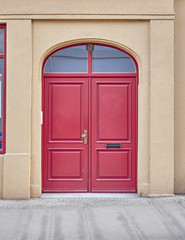 vintage house's vibrant red arched door