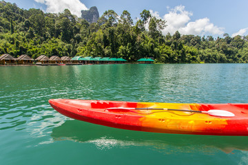 Fototapeta na wymiar Canoe in a beautiful mountains lake forest and river natural attractions in Ratchaprapha Dam at Khao Sok National Park, Surat Thani Province, Thailand.