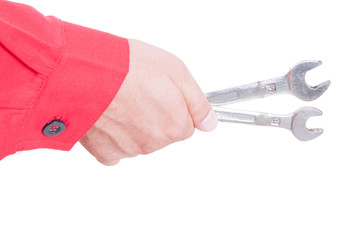 Mechanic or plumber hand holding wrenches