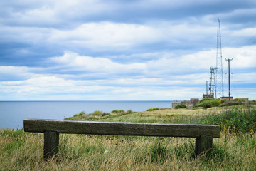 Wooden bench with the look at blue sea and the horizon