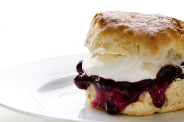 Jam and cream scones on white