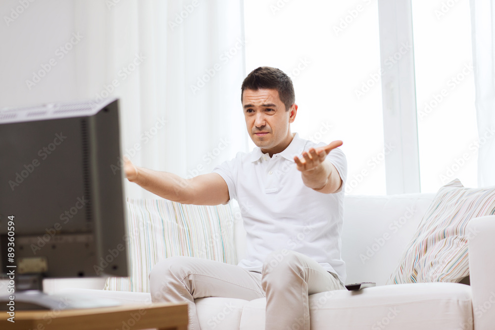 Poster disappointed man watching tv at home