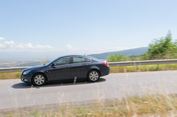 Obraz na płótnie Canvas car driving at high speed in empty road