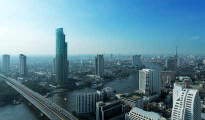 Fototapeta na wymiar Chao Phraya river and high building sky scrapper in heart of ban