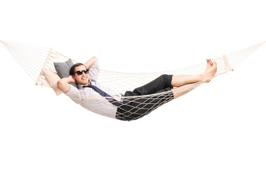 Carefree young businessman lying in a hammock