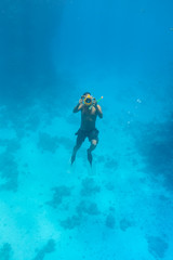 Underwater coral reef with cameraman