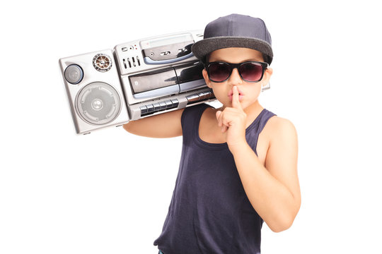 Little boy in hip-hop outfit carrying a ghetto blaster