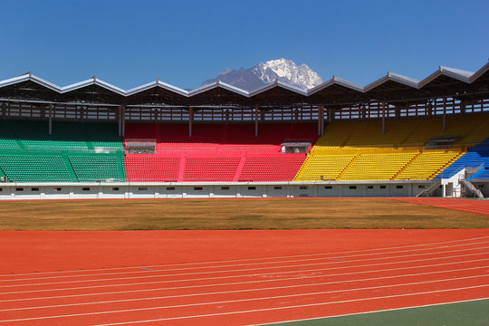 New empty colorful stadium with beautiful mountain in background