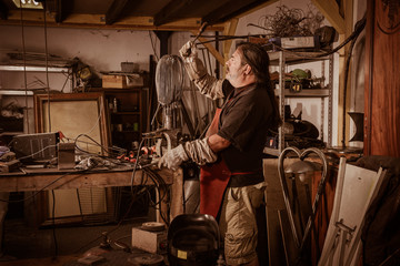 Metal worker standing in workshop