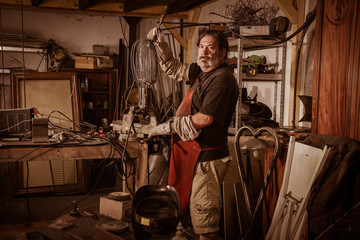 Metal worker standing in workshop