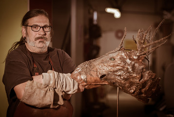 Portrait of a sculptor with one of his works artistic metal