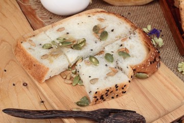 Brown bread with whole grain cereals of sliced and milk.