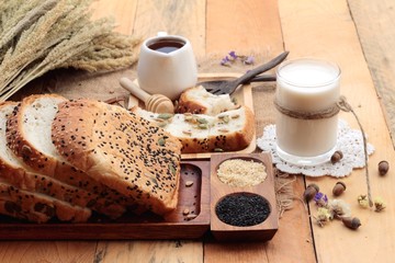Fototapeta na wymiar Brown bread with whole grain cereals of sliced and milk.