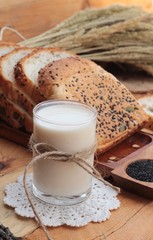 Brown bread with whole grain cereals of sliced and milk.