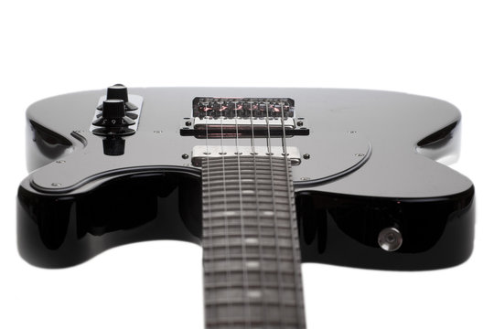 black electric guitar on a white background