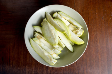 Mango peeled on a dish on wooden table