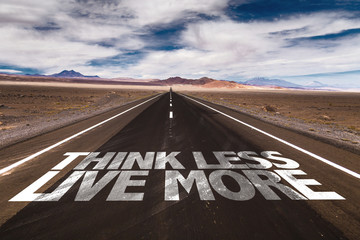 Think Less Live More written on desert road