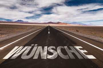 Wishes (in German) written on desert road