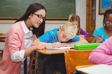 Smiling teacher helping a student