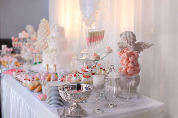 Dessert table for a party. Ombre cake, cupcakes, sweetness and f