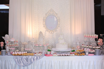Dessert table for a party. Ombre cake, cupcakes, sweetness and f