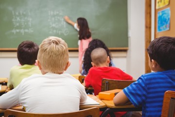 Teacher writing on the blackboard