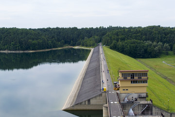 Dam of hydroelectric power plant with people walking