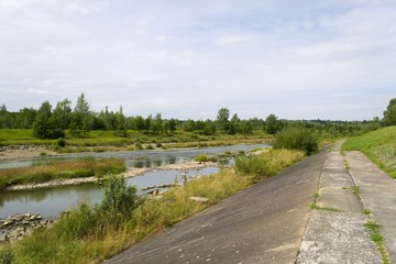 Fototapeta na wymiar Shallow river in Canada behind a hydroelectric plant dam