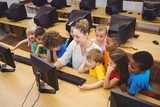 Teacher showing students how to use a computer