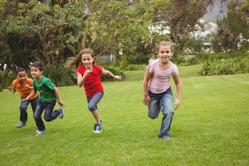 Fototapeta premium Happy kids running across the grass