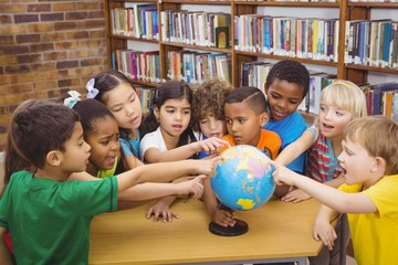 Fototapeta premium Students pointing at a globe