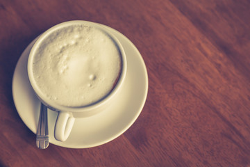 Hot latte art coffee on table ( Filtered image processed vintage