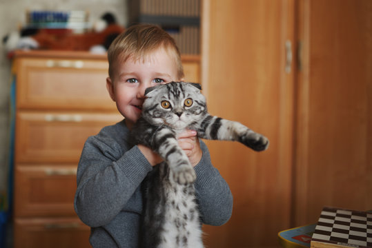 Little Funny Boy Hugs Cat