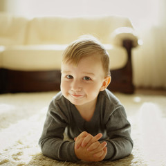 Fototapeta premium little boy lying on the carpet