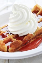 traditional waffle with cream and syrup