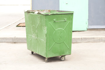 Green recycling container on the street
