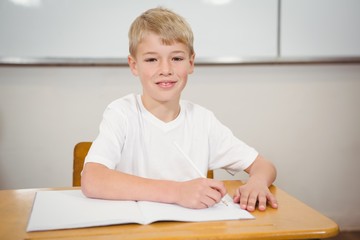 Naklejka premium Pupil sitting at a school desk
