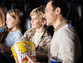 Family Watching Movie In Cinema Theater