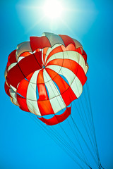 open parachute in the bright blue sky