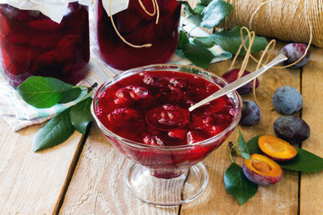 Plum canned plum juice cans on a wooden table