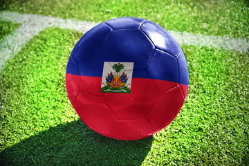 Fototapeta premium football ball with the national flag of haiti