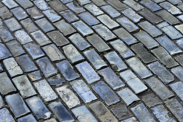 A wet blue cobblestone surface.