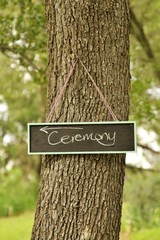 People: wedding ceremony sign on a tree