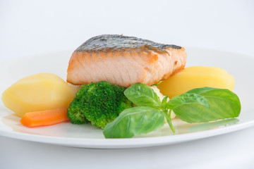 salmon fillet with potato on the white plate 